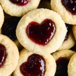 Heart Jam Cookies with raspberry jam filling, soft and buttery, perfect for Valentine's Day or any special occasion.