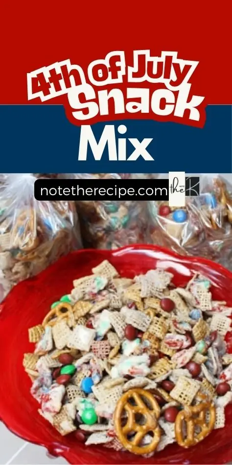 Patriotic snack mix in a red bowl with pretzels, cereal, and colorful chocolate candies, shown with gift bags in the background and 4th of July Snack Mix text overlay.
