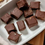 Chocolate peanut butter freezer bites arranged in a white dish, topped with sea salt flakes