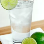 Chilled glass of coconut lime slim soda with ice and lime garnish
