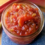 Sweet and tangy rhubarb relish recipe with strawberries in a glass jar