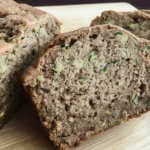 Close-up of moist old fashioned zucchini bread with grated zucchini and walnuts