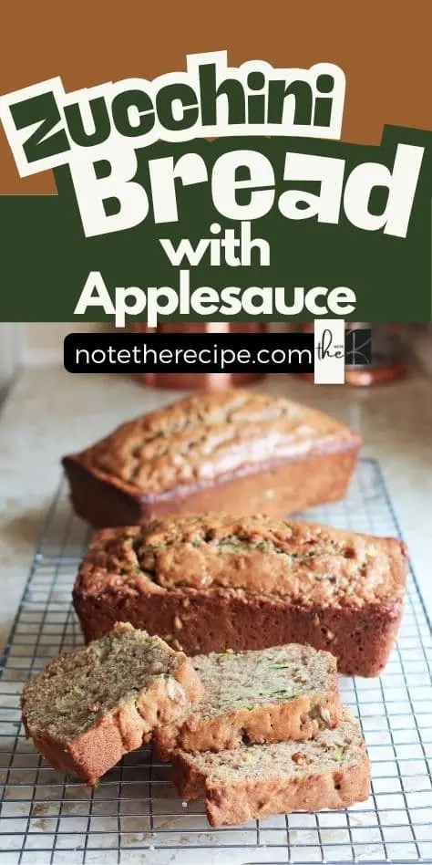 Vertical Pinterest pin showing sliced and whole zucchini bread with applesauce on a cooling rack, with bold recipe title and notetherecipe.com branding.
